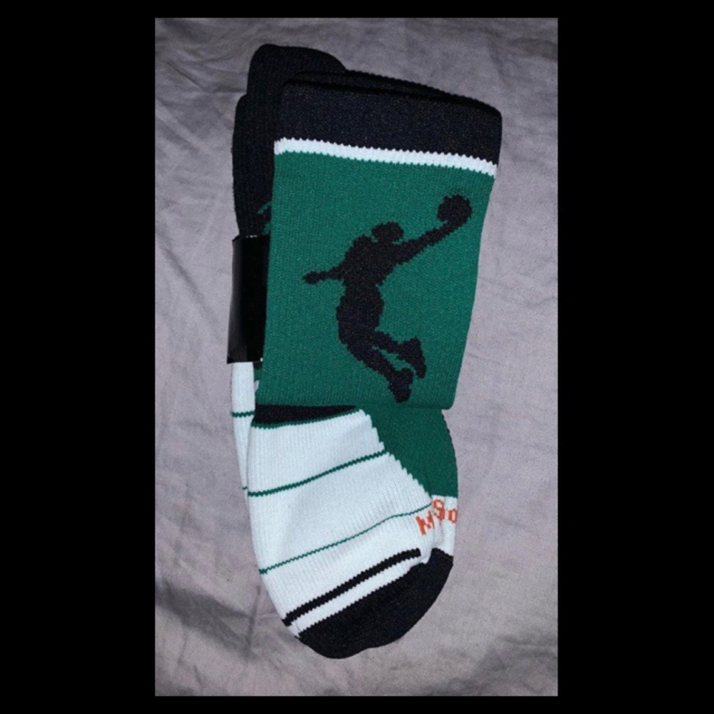 Green, black, and white athletic basketball socks.